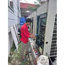 HVAC technician working beside outdoor cooling equipment